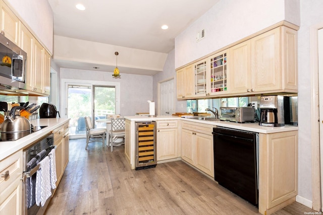 kitchen featuring black appliances, wine cooler, decorative light fixtures, light hardwood / wood-style floors, and kitchen peninsula