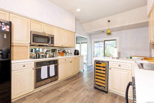 kitchen with light wood-type flooring, wine cooler, lofted ceiling, and black appliances