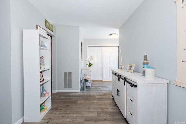 interior space featuring dark hardwood / wood-style flooring and white cabinetry