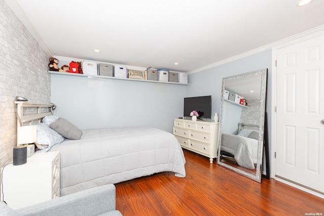 bedroom featuring crown molding and dark wood-type flooring