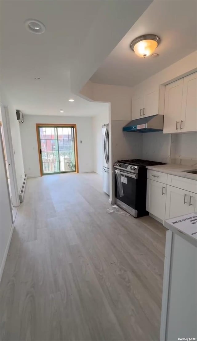 kitchen featuring baseboard heating, white cabinets, light hardwood / wood-style floors, and appliances with stainless steel finishes