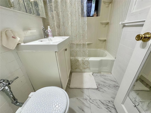 full bathroom featuring vanity, toilet, tile walls, and shower / bath combo with shower curtain