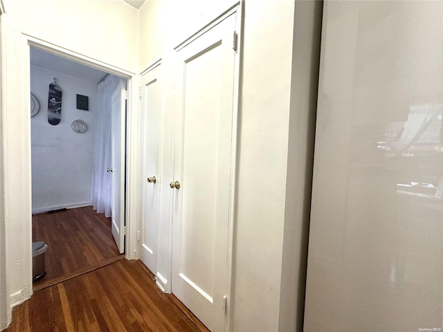 corridor with hardwood / wood-style floors