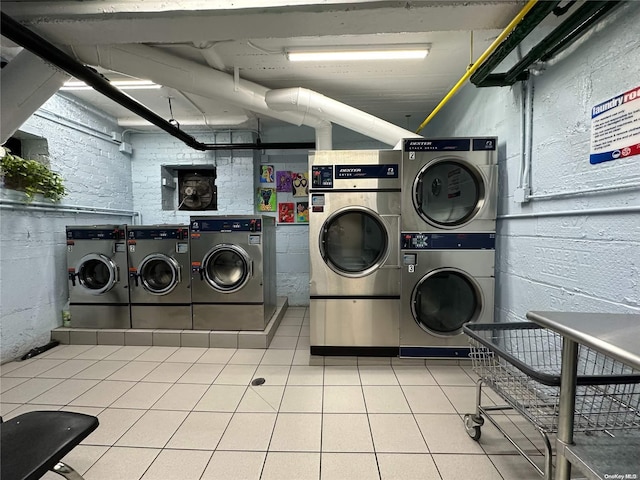 laundry room with separate washer and dryer, tile patterned floors, and stacked washer / drying machine