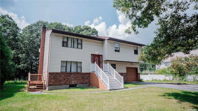 view of front of home with a front lawn and a garage