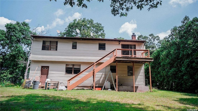 back of house featuring a deck and a yard