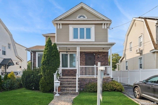 view of front facade featuring covered porch and a front yard