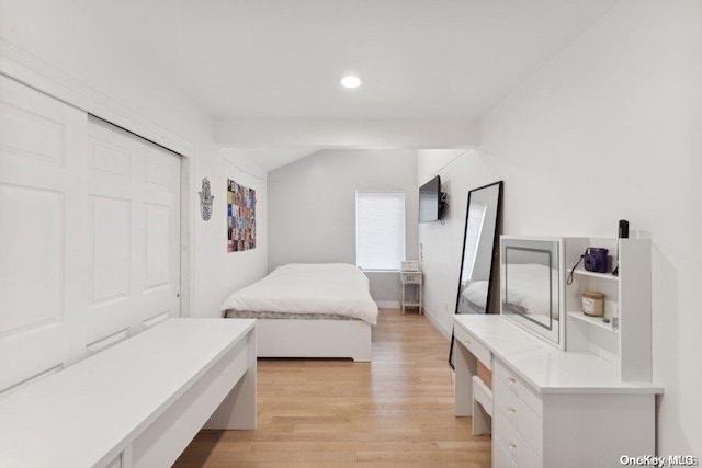 bedroom with a closet and light hardwood / wood-style flooring