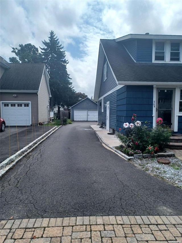 view of home's exterior with an outbuilding and a garage