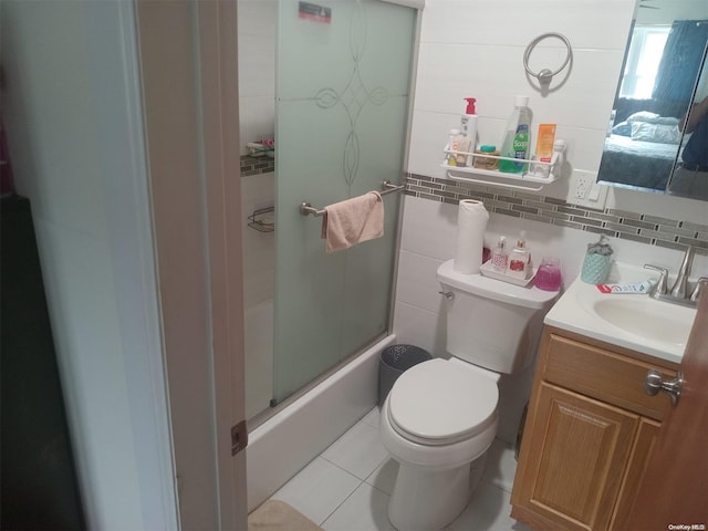 full bathroom featuring backsplash, vanity, enclosed tub / shower combo, tile patterned flooring, and toilet