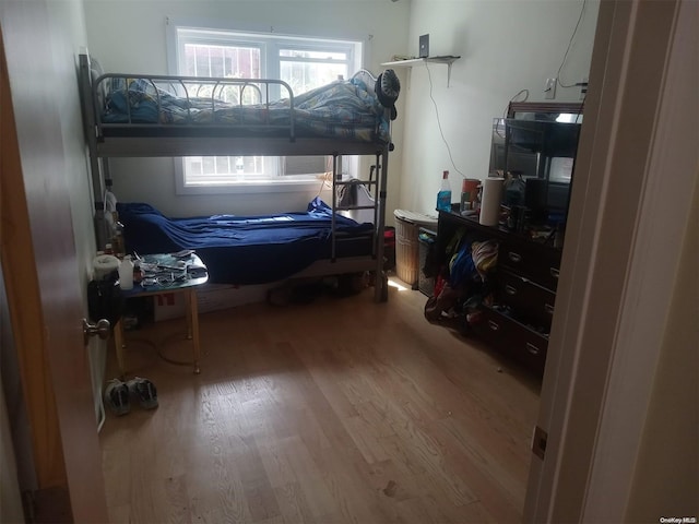 bedroom with wood-type flooring