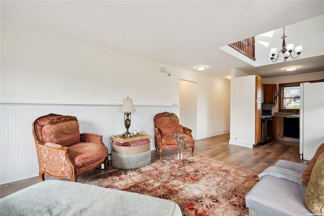 living room with hardwood / wood-style flooring and an inviting chandelier