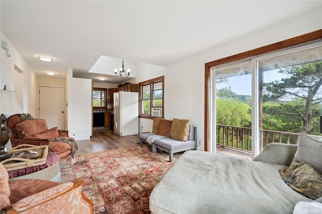 living room featuring a chandelier, wood-type flooring, and cooling unit