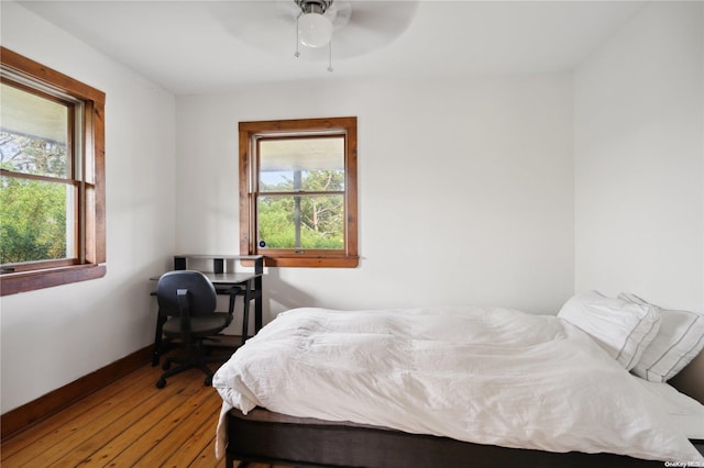 bedroom with hardwood / wood-style floors and ceiling fan