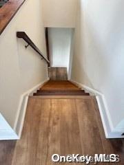 stairway with hardwood / wood-style flooring