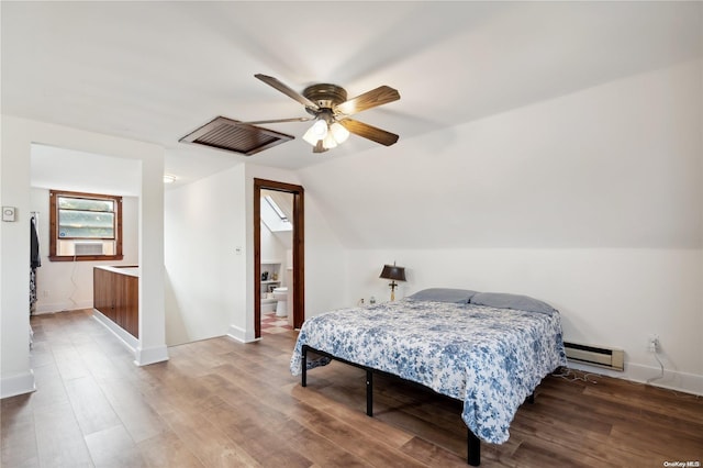 bedroom featuring baseboard heating, ceiling fan, wood-type flooring, and vaulted ceiling