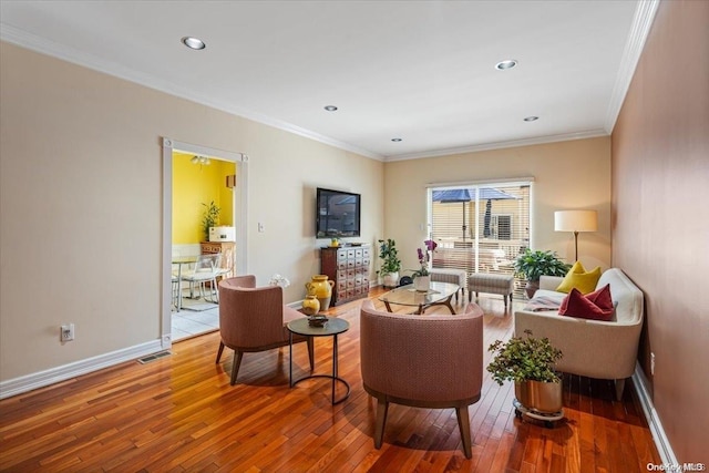 living room featuring hardwood / wood-style flooring and ornamental molding