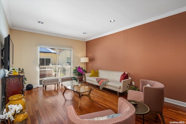 living room featuring wood-type flooring and ornamental molding