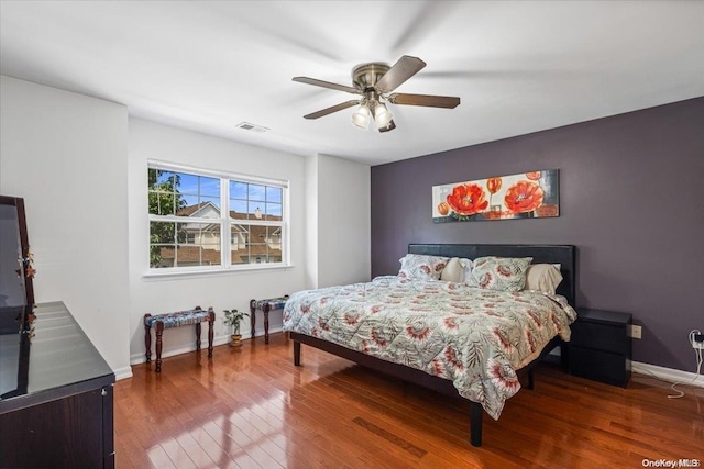 bedroom featuring ceiling fan and dark wood-type flooring