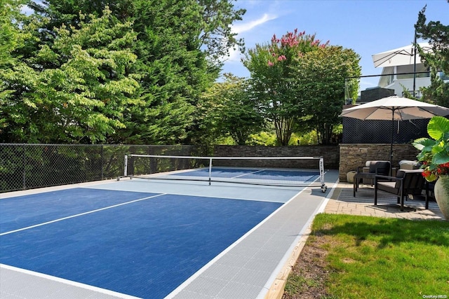 view of tennis court with basketball hoop