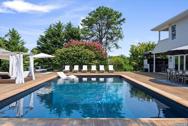 view of swimming pool featuring a wooden deck