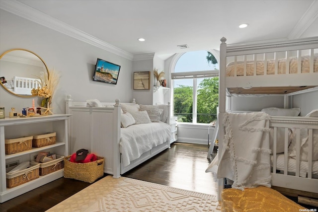 bedroom with crown molding and dark wood-type flooring