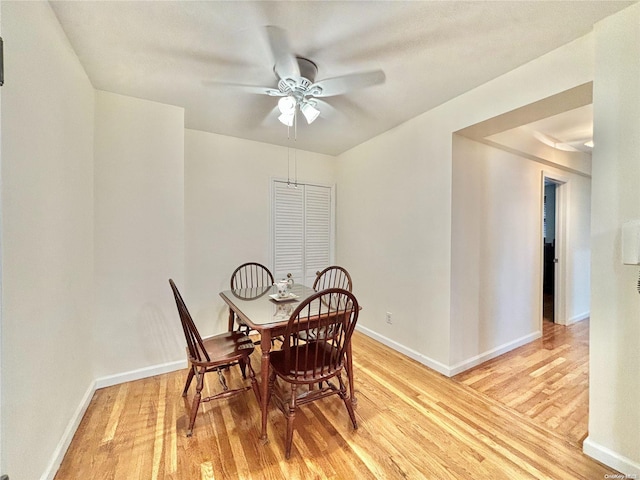 dining space with hardwood / wood-style floors and ceiling fan