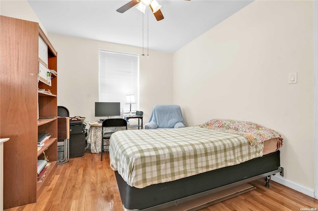 bedroom with light hardwood / wood-style flooring and ceiling fan