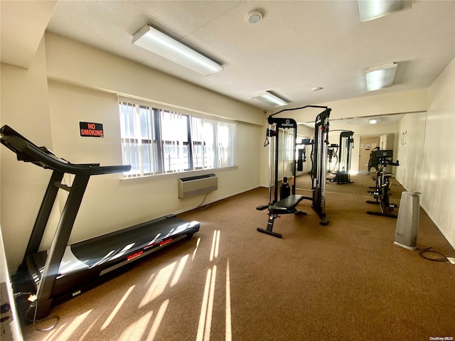 workout room featuring a wall mounted air conditioner