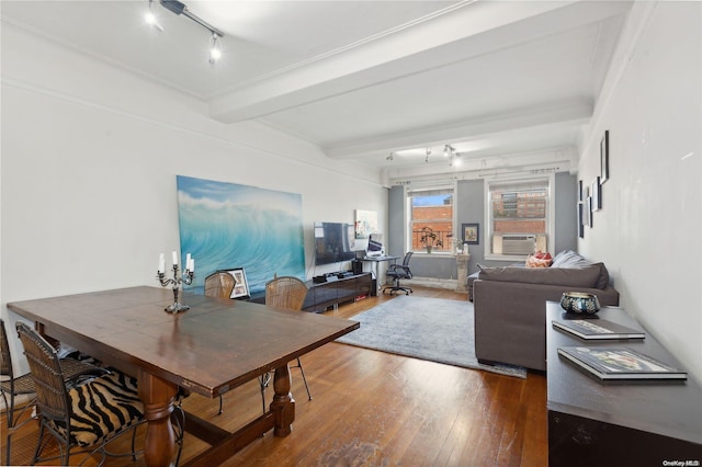 dining space featuring hardwood / wood-style flooring and beam ceiling