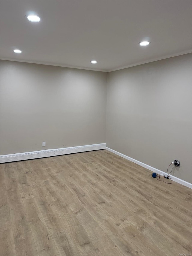 basement with light wood-style floors, recessed lighting, ornamental molding, and baseboards