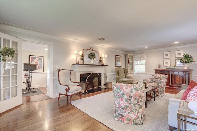 living room with light wood-type flooring and crown molding