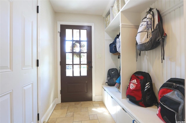 122 Roxen Rd, Rockville Centre, NY 11570 - mudroom featuring stone tile floors, healthy amount of natural light, wallpapered walls, and baseboards