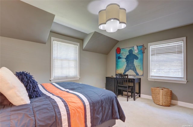 carpeted bedroom with vaulted ceiling