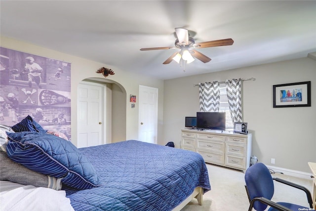 bedroom featuring light carpet and ceiling fan