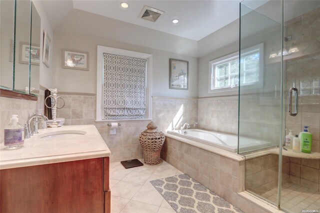 122 Roxen Rd, Rockville Centre, NY 11570 - bathroom with vanity, tile patterned flooring, a garden tub, a shower stall, and wainscoting