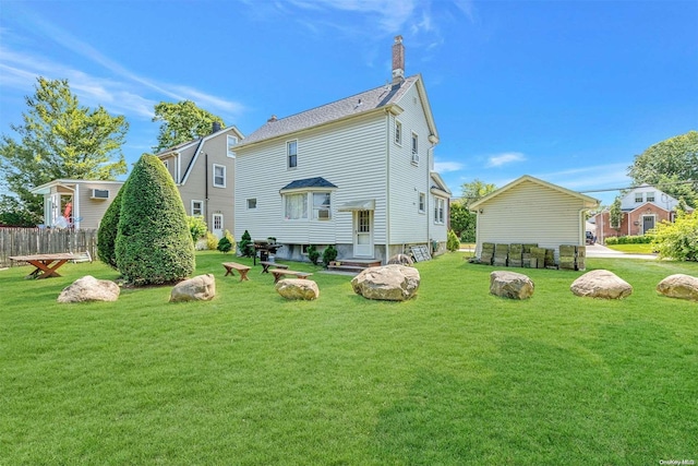 back of property featuring a lawn