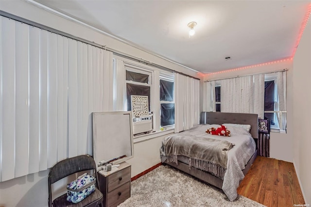 bedroom featuring light hardwood / wood-style floors and cooling unit