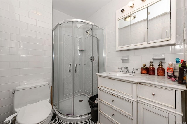 bathroom featuring vanity, a shower with shower door, and tile walls