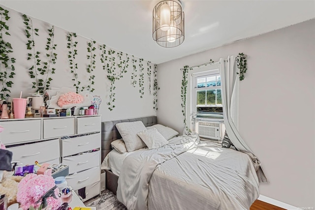 bedroom featuring cooling unit and hardwood / wood-style flooring