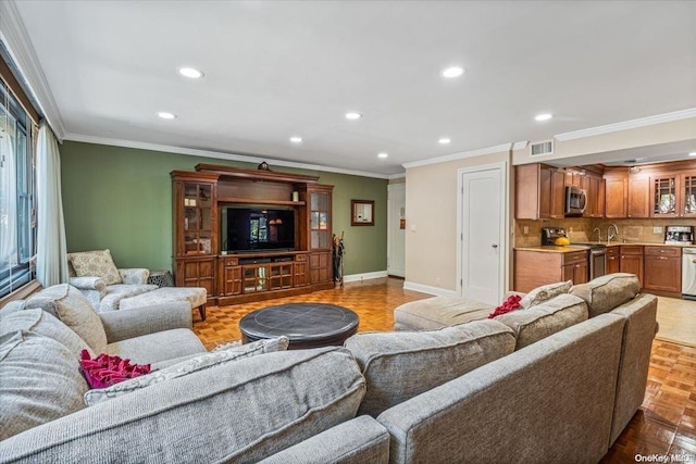 living room featuring light parquet flooring, ornamental molding, and sink