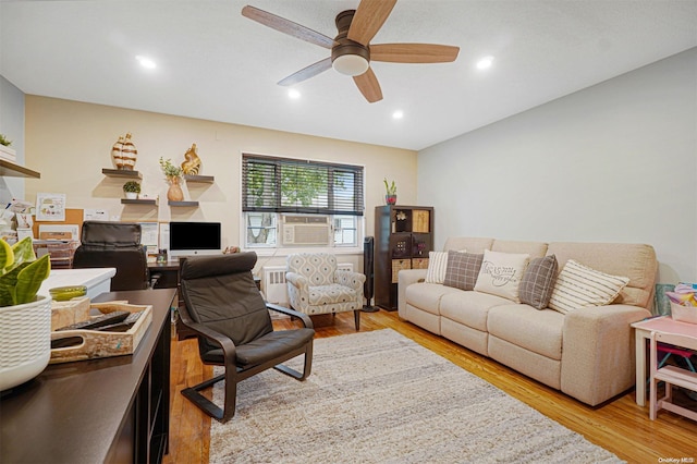 living room featuring light hardwood / wood-style floors, ceiling fan, and cooling unit