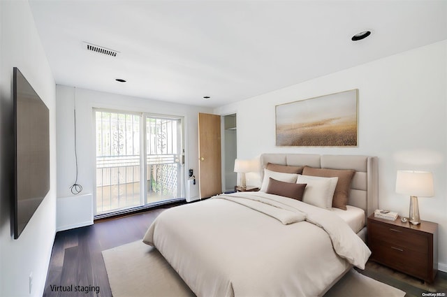 bedroom with dark wood-type flooring