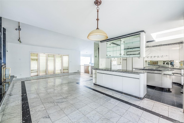 kitchen featuring white cabinets and hanging light fixtures