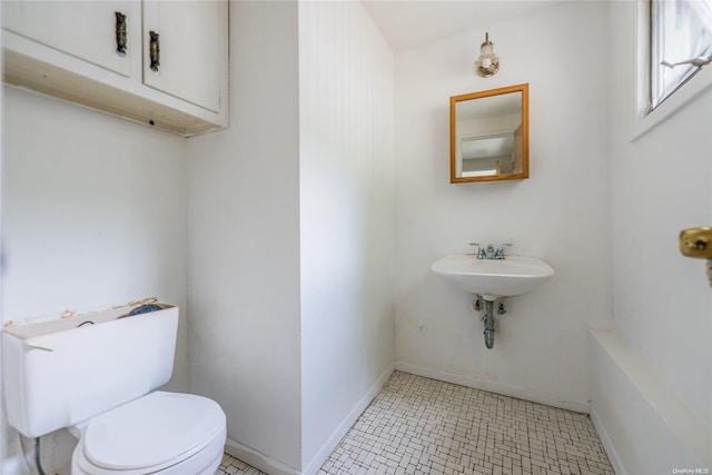 bathroom featuring tile patterned flooring, toilet, and sink