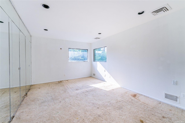 unfurnished bedroom featuring light colored carpet