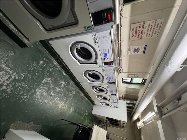 clothes washing area with stacked washer and clothes dryer