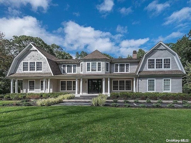 back of house with a lawn and a porch