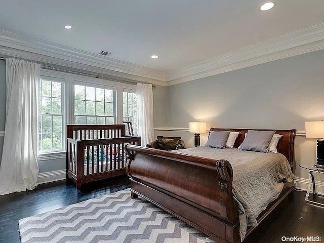 bedroom featuring wood-type flooring and ornamental molding