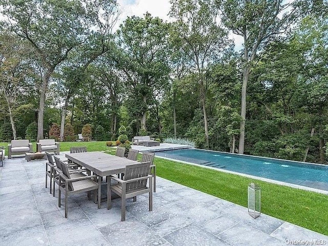 view of swimming pool featuring a patio area and a lawn